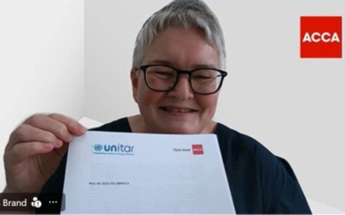 Screenshot image of the ACCA Executive Director holding a signed Memorandum of Understanding