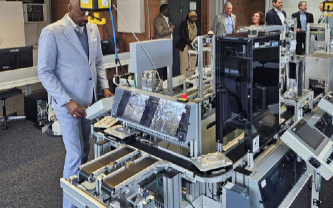 CIFAL Dakar Director Diop examining newly installed machinery during a facility inspection in Siegen, Germany