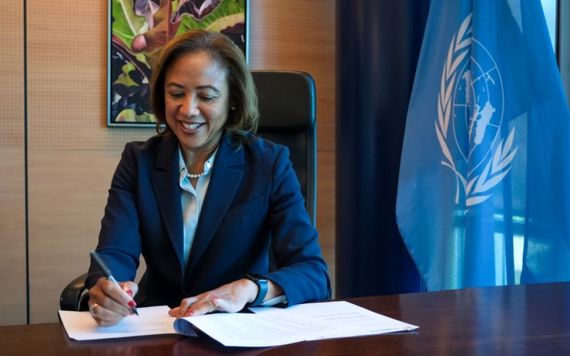 UNITAR Executive Director signing a Memorandum of Understanding in her office during an online signing ceremony