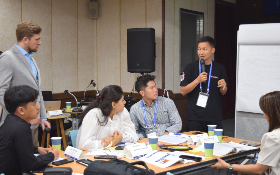 Participant presenting action plans and insights to a group during the workshop.