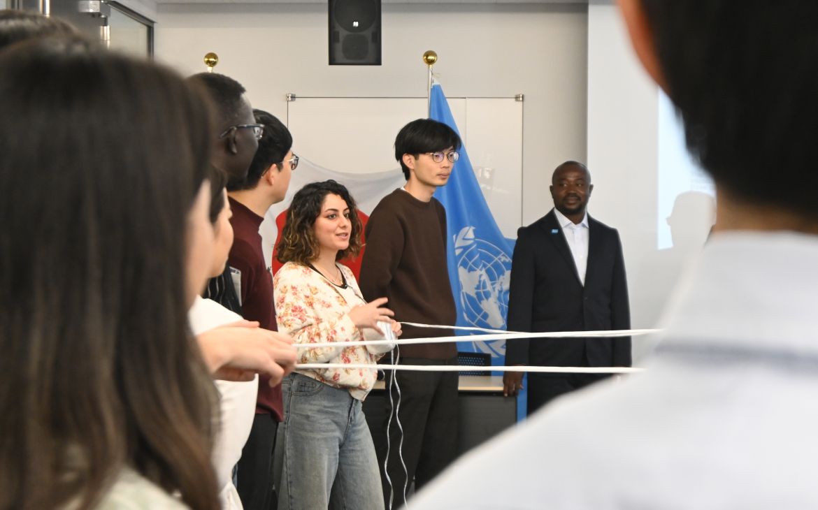 A group of participants joining in a training session, holding strings