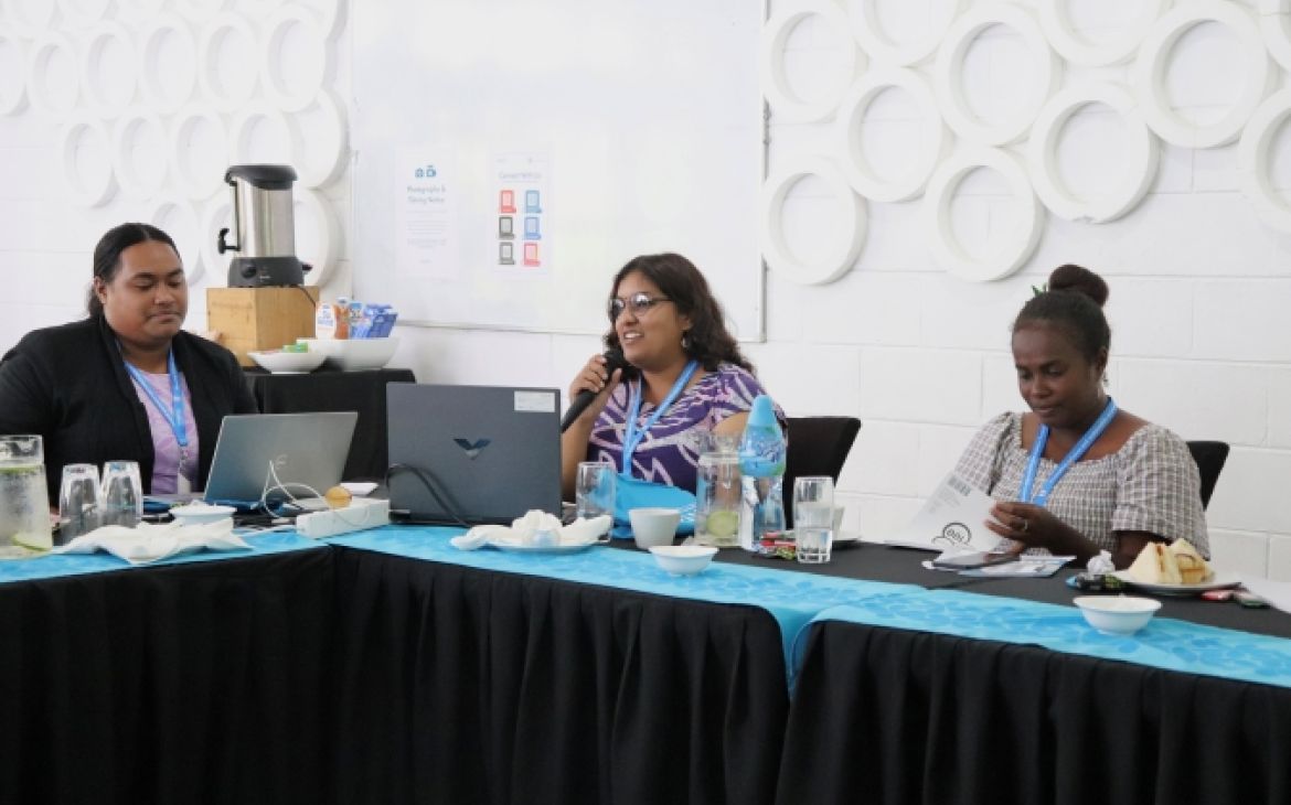 Participant sitting in a lecture session and speaking through a microphone
