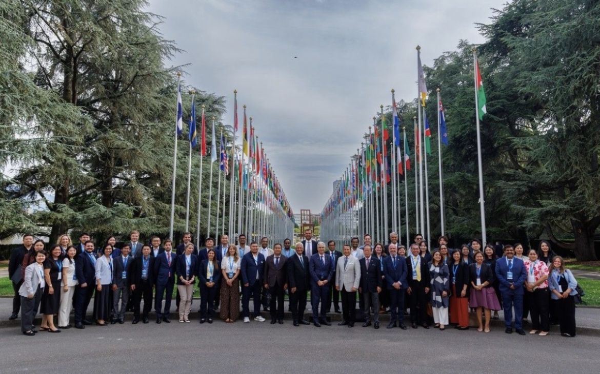 Participants gathered in front of the Alley of Flags in the Palais des Nations