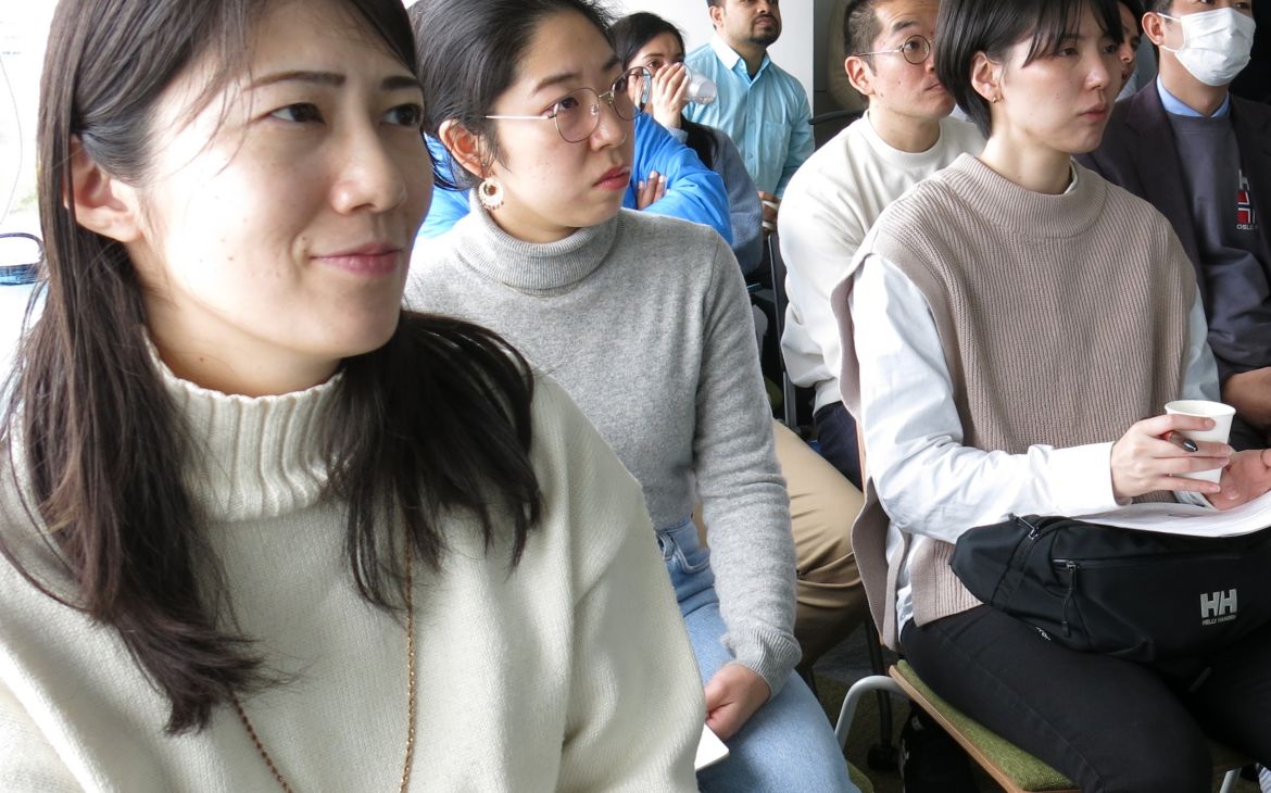 Participants sitting and listening to a speaker