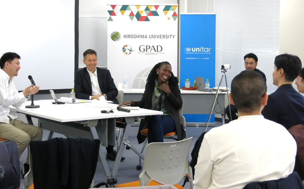 A participant speaking in a discussion with fellow participants