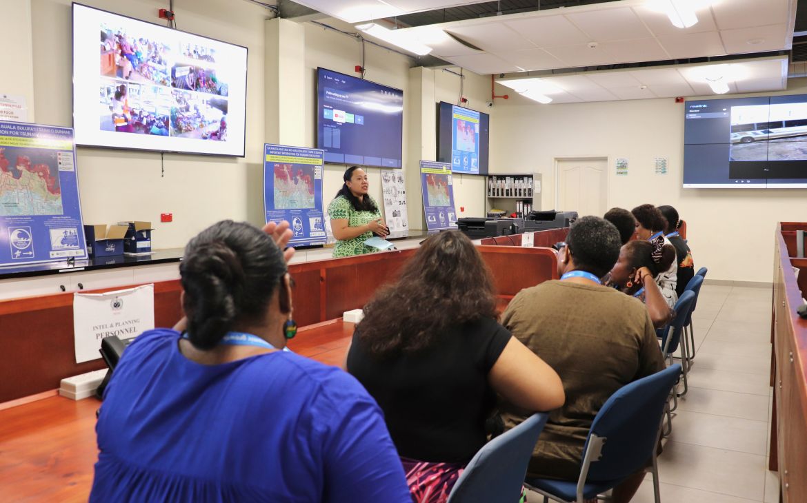 A group of participants sitting and listening to a lecture at a study tour