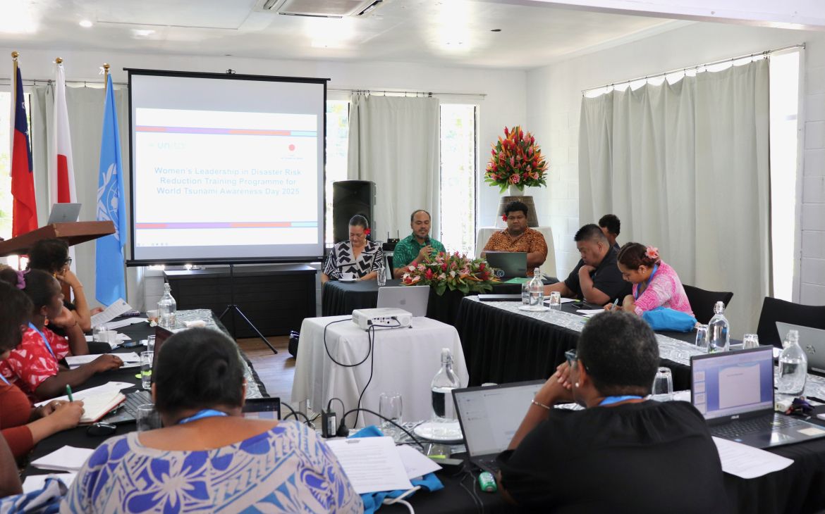 A group of participants participating in a group discussion in a room with a screen in the front
