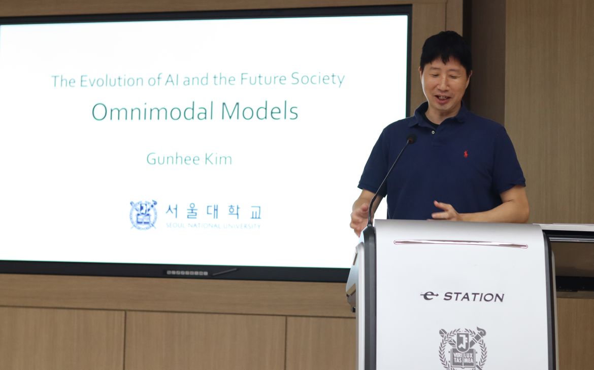 Dr. Gunhee Kim presents in front of the stage. 