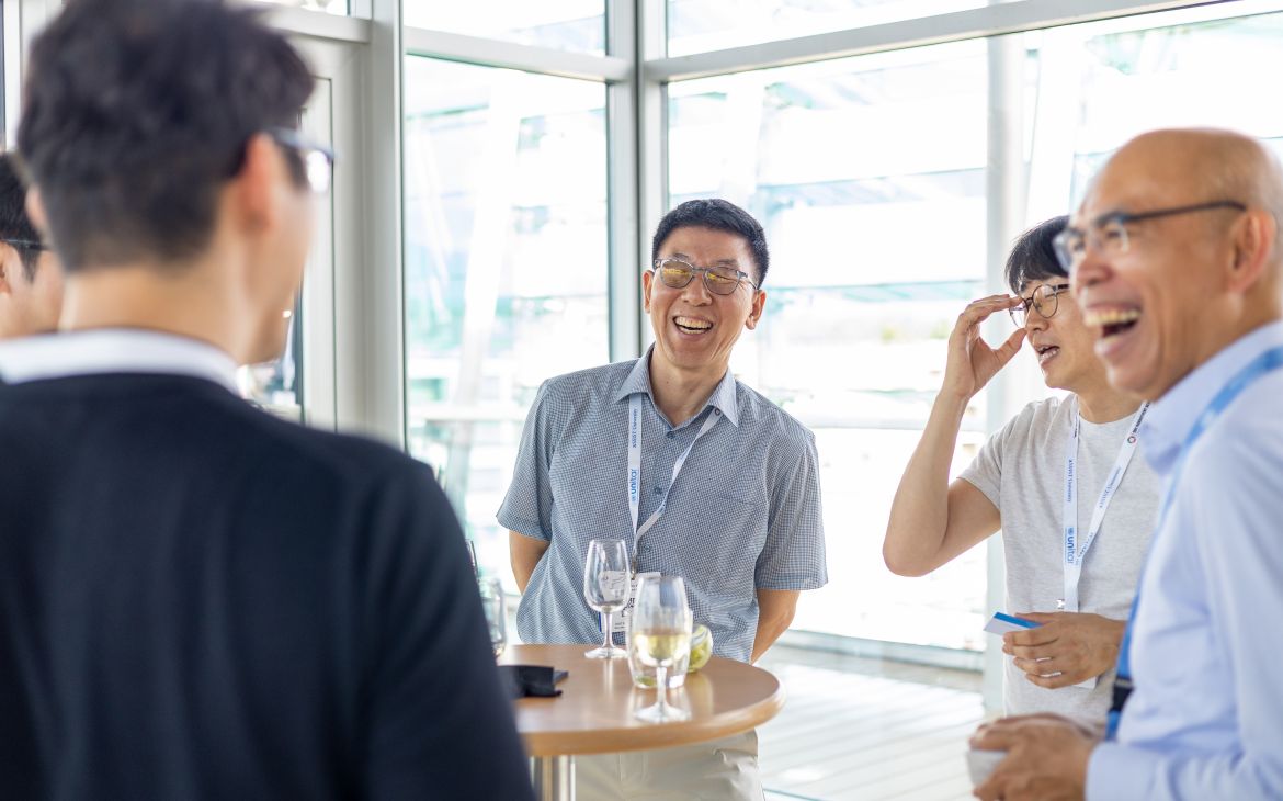 Participants talk and laugh in a circle. 