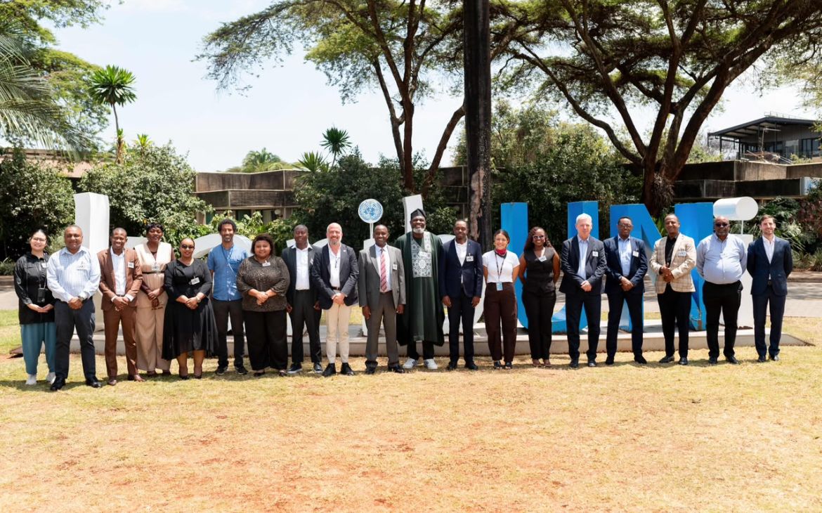 Group of participants posing in front of a sculpture