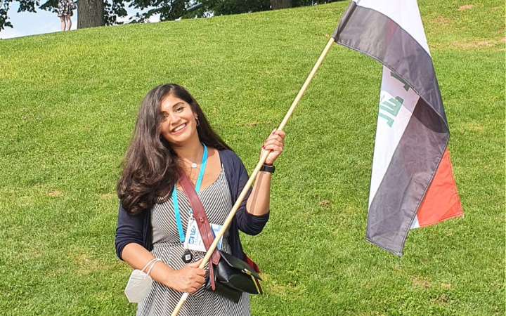 Hana Ali carrying the flag of Iraq