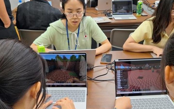 Participants working with their laptop in a room