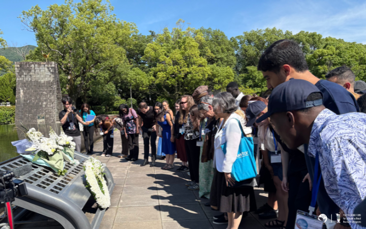 Participants in front of a monument at the Nagasaki Peace Park