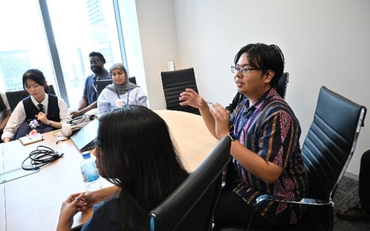 UNITAR training participating discussing with the team in a meeting room