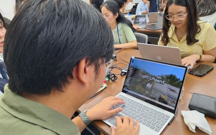UNITAR training participant using a laptop computer to learn through MInecraft