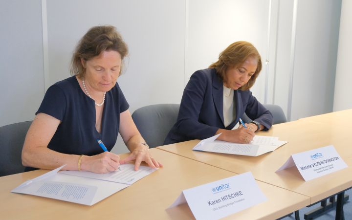 Karen Hitschke, CEO of Building Bridges, and Michelle Gyles-McDonnough, UN Assistant Secretary-General and Executive Director of UNITAR, signing the MoU.