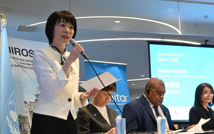 Ms. Mika Yokota, Governor of Hiroshima Prefecture and Representative of the Hiroshima Organization for Peace (HOPe) speaking through a microphone to the young participants