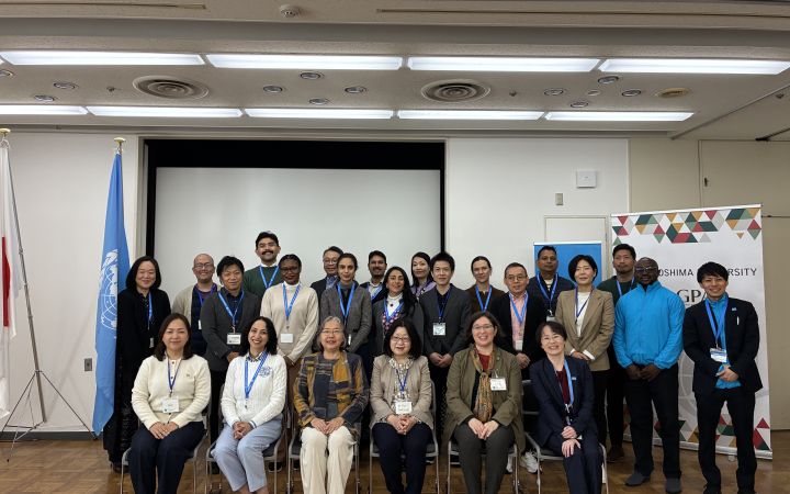 A group picture in a room with approximately 30 people