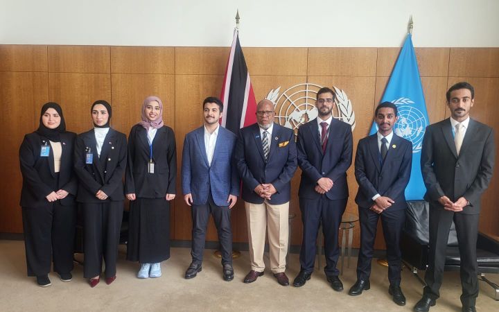 A group photo of the Qatar Fellows and H.E. Dennis Francis