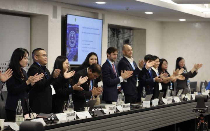 A group standing and clapping during a workshop session