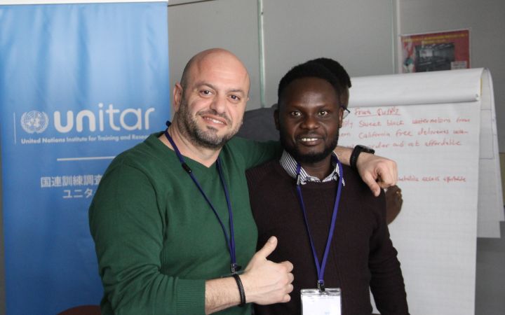 John Ladu Simon Jacob taking a photo with participant from Lebanon of the joint workshop of the 2023 Great Ideas Space for South Sudan: Entrepreneurship and Innovation Training for Food Security programme