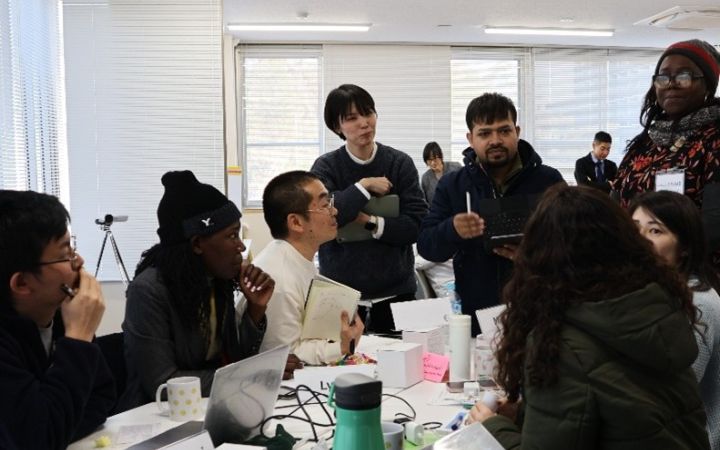 A group of people in discussion around a table