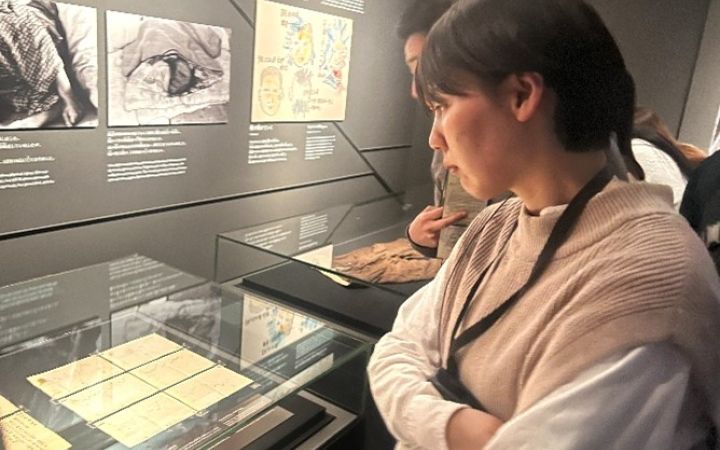 Primary Course alum reading a description at the Hiroshima Peace Memorial Museum