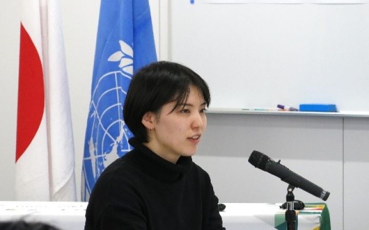 A person speaking at a podium in a room