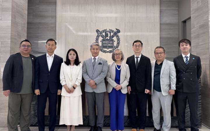A group photo of representatives from UNITAR and Seoul National University standing together in an office setting.