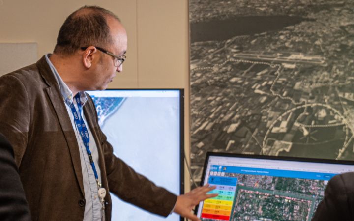 UN Satellite Centre analysist pointing to the satellite image on screen