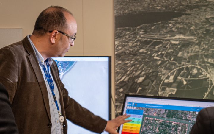 UN Satellite Centre analysist pointing to the satellite image on screen