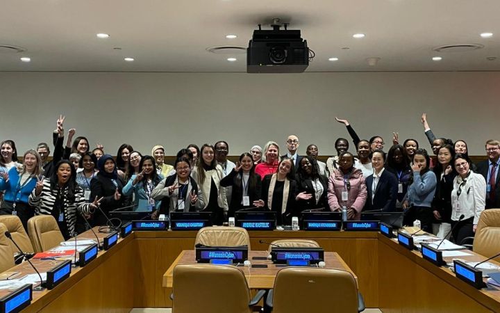 In a UNHQ conference room, women celebrate conclusion of Fellowship session