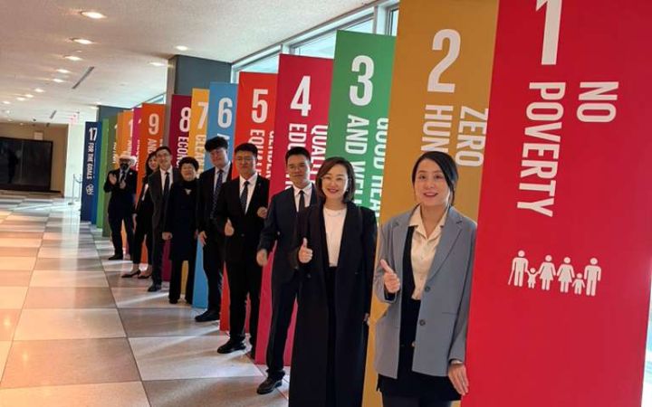 Education leaders in front of the SDGs on their UNHQ Tour