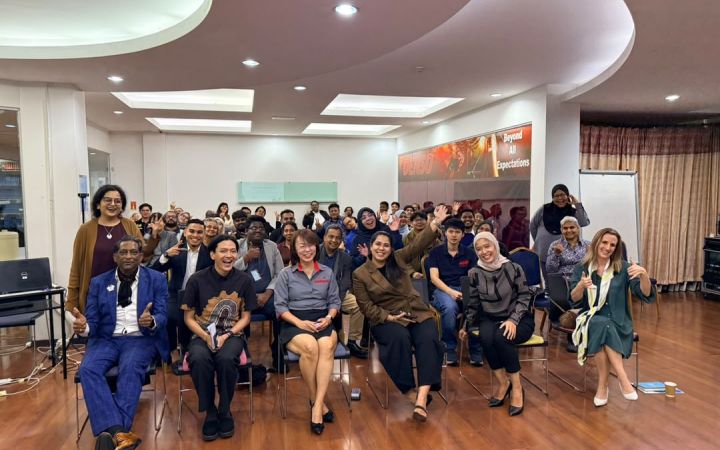 Group photo of the participants and experts in a conference hall.