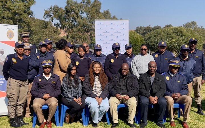 Participants and trainers assembling for a group photo
