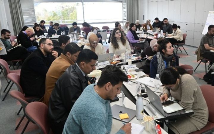 UNITAR training participants sitting in groups for an expert-led lecture
