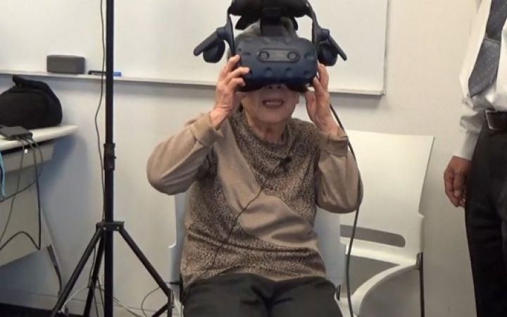 A local citizen takes in VR footage produced by students