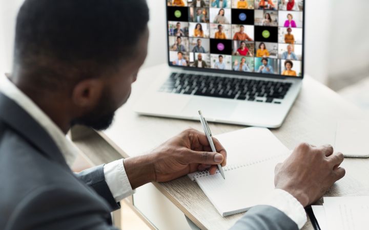 Webinar Session with a Person Taking Notes