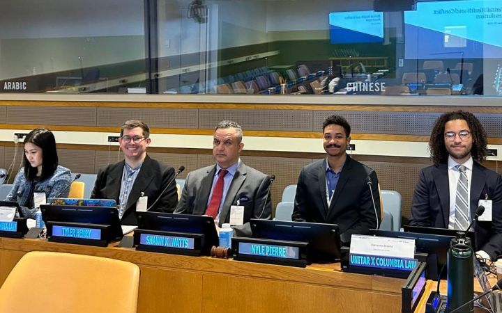 Speakers seated in front at the beginning of the session