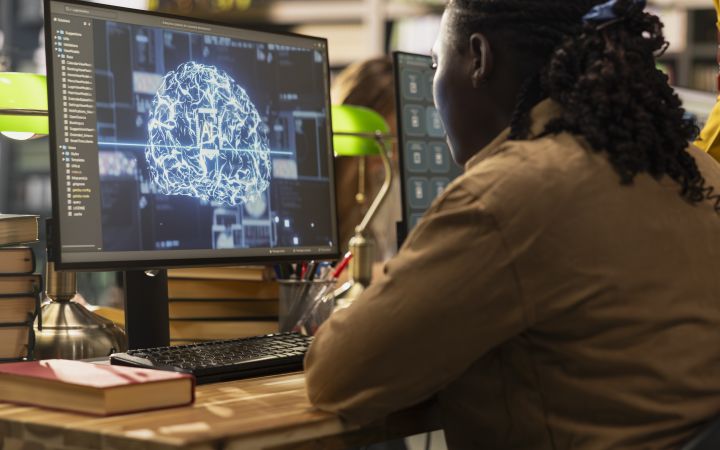 A student using a computer to learn more about Artificial Intelligence.