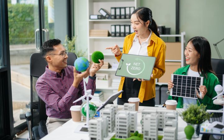 Stock image of a discussion taking place with three participants, one standing and two on both sides.