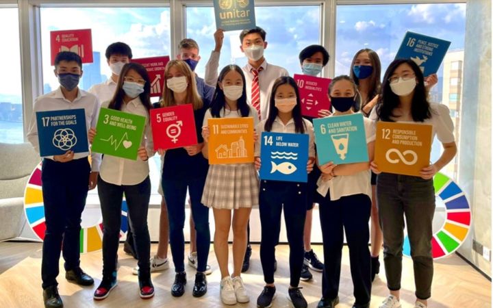 Group of young people with SDG promotional materials.