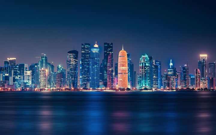 Body of Water Across City Buildings during Nighttime