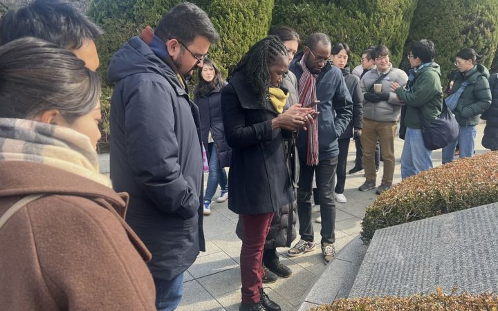 Participants from the Primary Course of the Program for Global Human Resource Development for Peacebuilding and Development gathering at the Hiroshima Peace Memorial Park