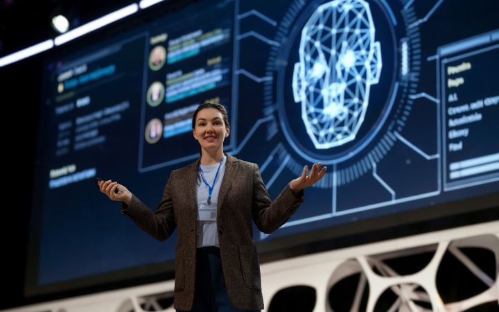 Woman is speaking on stage.